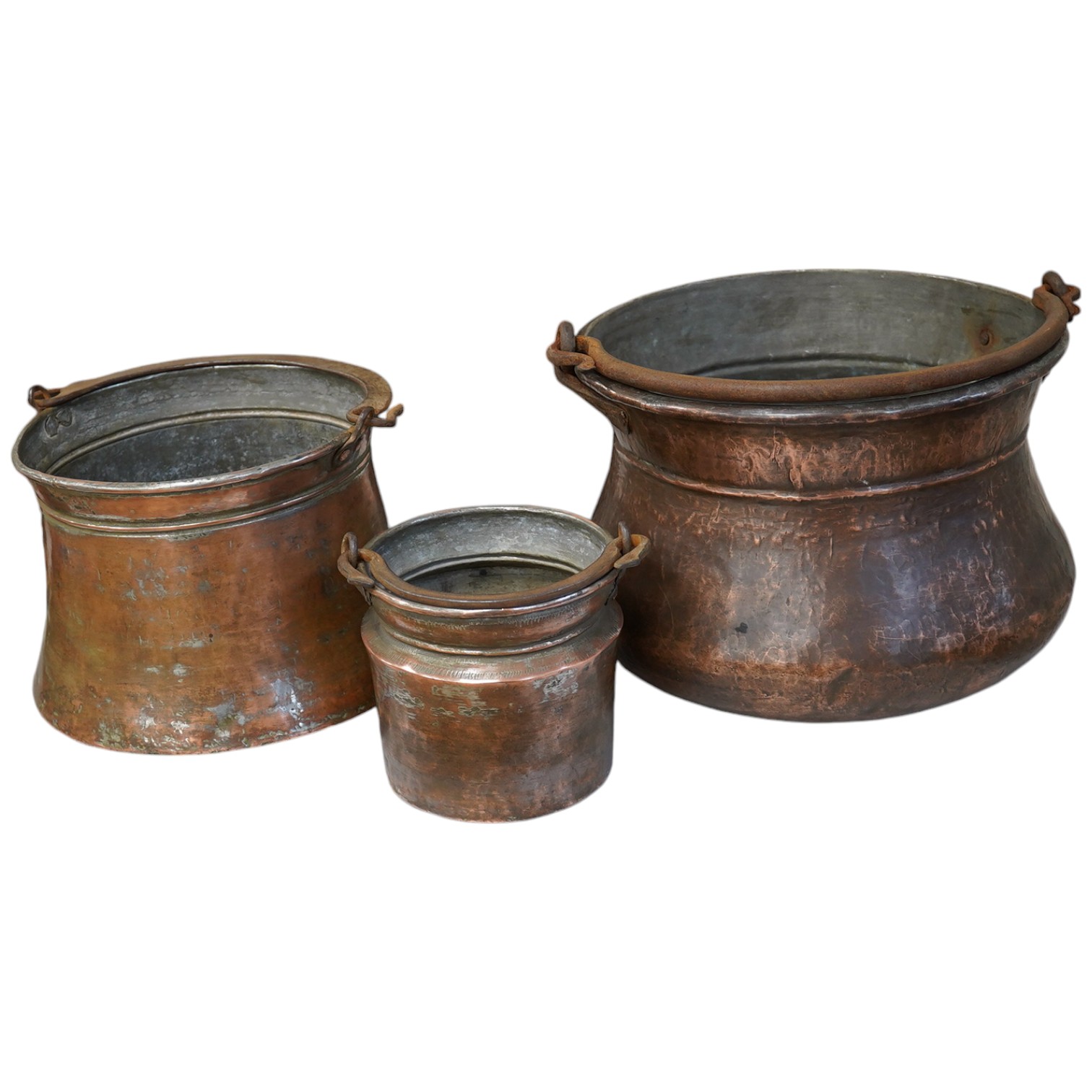 A set of three graduated coppered buckets with swing handles. Largest 22cm high. Condition - fair